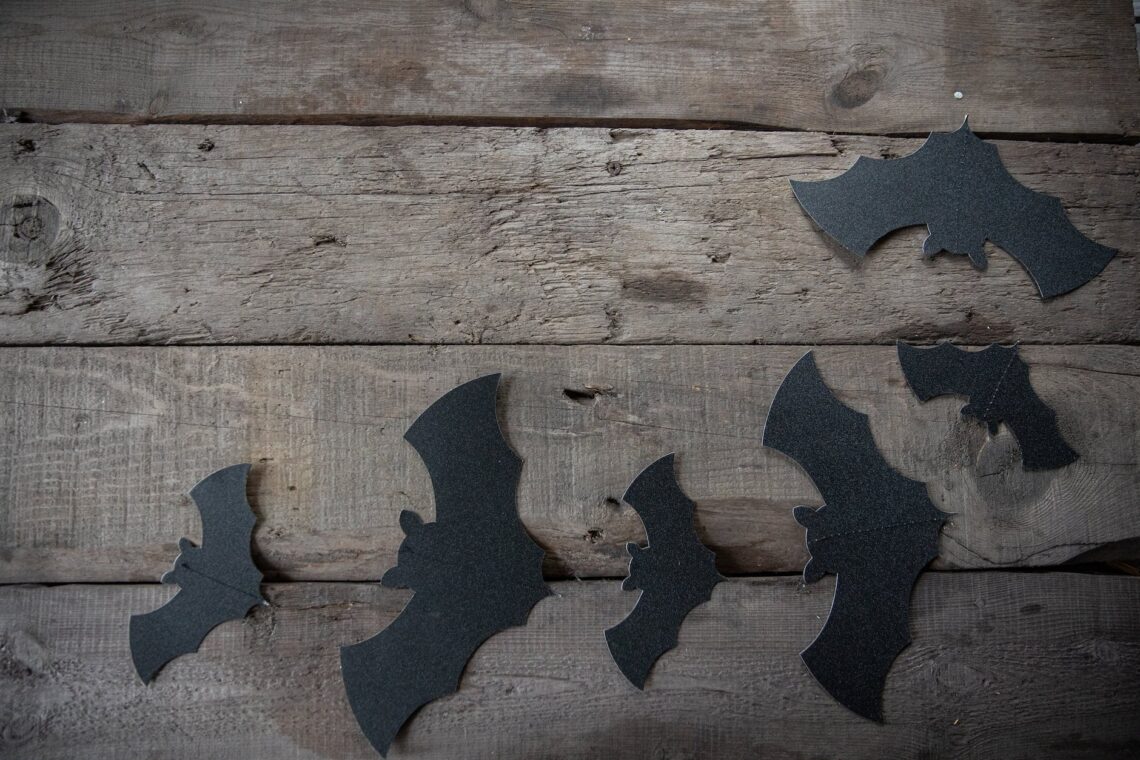 black paper bats decors on wooden table